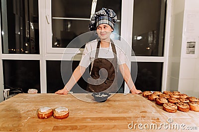 Woman bake pies. Confectioners make desserts. Making buns. Dough on the table Stock Photo