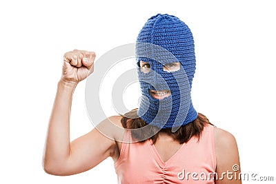 Woman in balaclava showing raised fist gesture Stock Photo