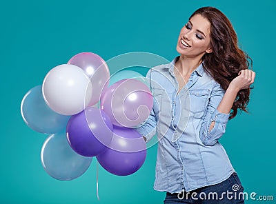 Woman with balloons in studio on a blue background Stock Photo