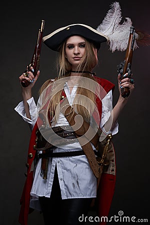 Woman bandit with tricorn in suit and dual handguns Stock Photo