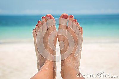 Woman bare sandy feet, beach and sea Stock Photo