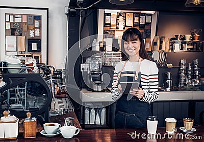 Woman barista take order with tablet,asia female waitress using Stock Photo