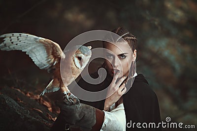 Woman with barn owl on her arm Stock Photo