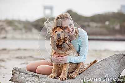 A woman on the beach with her Chocker Spaniel Stock Photo