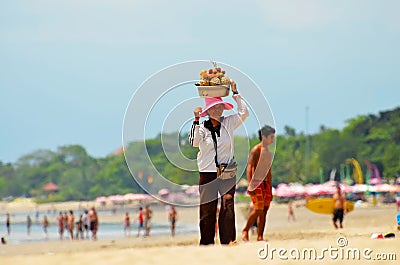 Woman on the beach selling fruit on the island of Bali. Indonesia, Denpasar 10 November 2011 Editorial Stock Photo