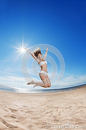 Woman on the beach. Young girl on the sand by sea. Stock Photo