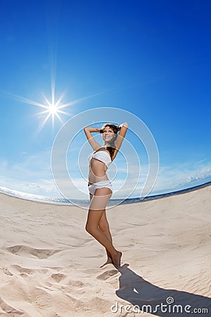 Woman on the beach. Young girl on the sand by sea. Stock Photo