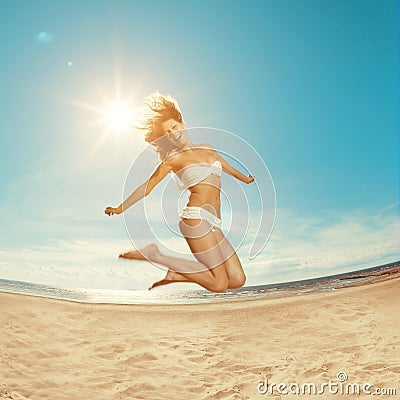 Woman on the beach. Young girl on the sand by sea. Stock Photo