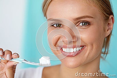 Woman With Beautiful Smile, Healthy White Teeth With Toothbrush Stock Photo