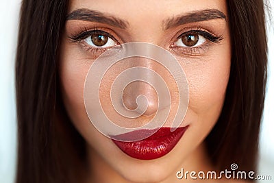 Woman With Beauty Face And Beautiful Makeup And Red Lips Stock Photo