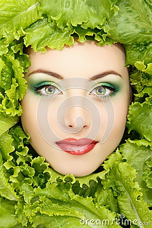 Woman beauty face with green fresh lettuce leaves Stock Photo