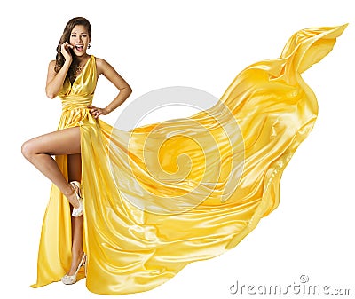 Woman Beauty Fashion Dress, Beautiful Girl In Flying Yellow Fluttering Gown, Standing on One Leg High Heels, Fabric Cloth Waving Stock Photo