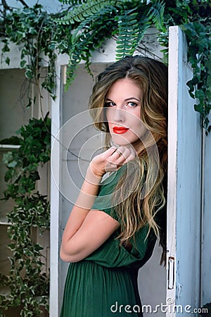 Woman in beauty fashion green gown, long evening dress with flowers Stock Photo