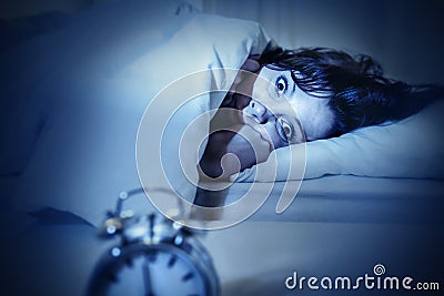 Woman in bed with eyes opened suffering insomnia and sleep disorder Stock Photo