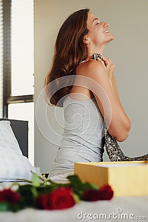 Woman, bedroom and box for gift, dress and happy with roses for birthday, valentines day or event. Girl, clothes and Stock Photo