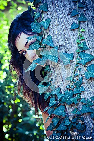 Woman behind leaves Stock Photo