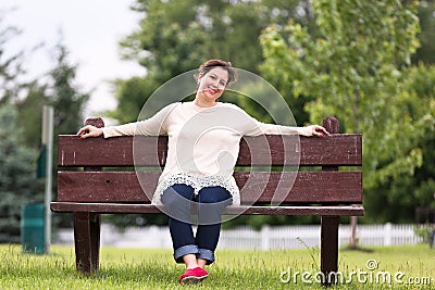 Woman on Bench Expressing her Positivity Stock Photo