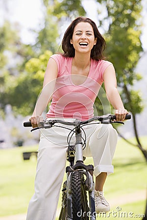 Woman on bicycle smiling Stock Photo