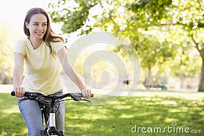 Woman on bicycle smiling Stock Photo