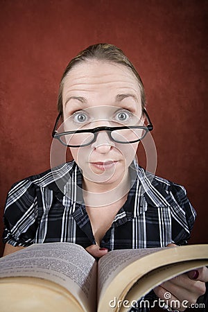 Woman with big eyes reading a book Stock Photo