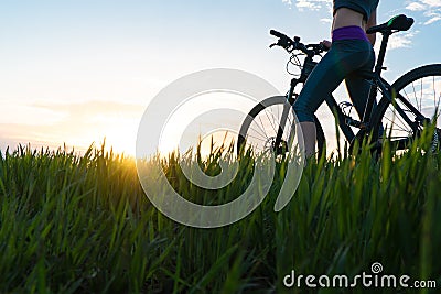 Woman bike sunset. exercise at sunset Stock Photo