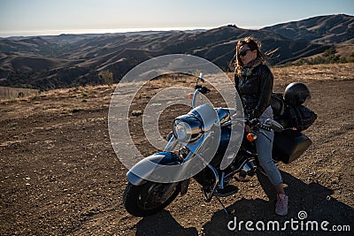 Woman biker sitting on her motorcycle Stock Photo