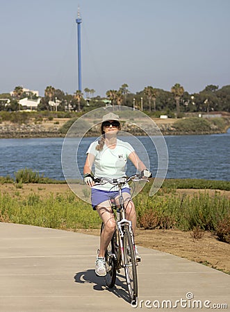 A Woman Bikes Fiesta Island, Mission Bay, San Diego Editorial Stock Photo