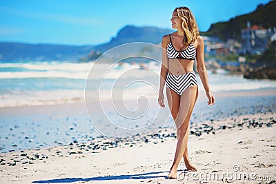 Woman, bikini and walk on beach with space for vacation mock up, happiness and fashion in summer. Girl, sexy swimsuit Stock Photo