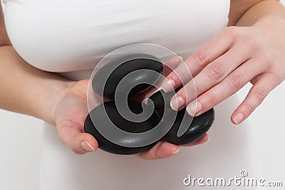 Woman Binging Hot Oiled Spa Stones Stock Photo