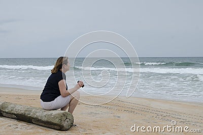 Woman with binoculars on beach 2 Stock Photo