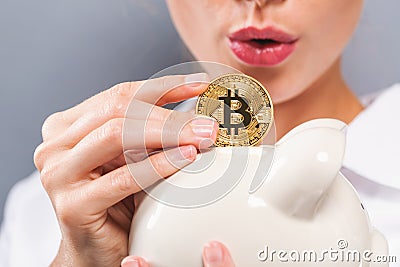 Woman with bitcoin and piggy bank Stock Photo