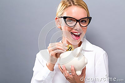 Woman with bitcoin and piggy bank Stock Photo