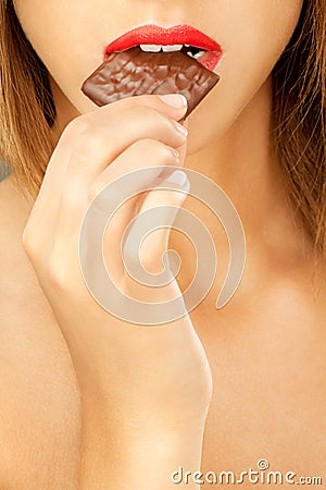 Woman bitting chocolate bar Stock Photo