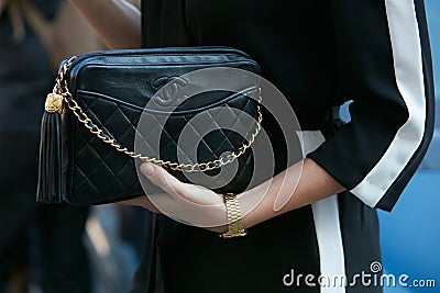 Woman with black Chanel leather bag and golden watch before Luisa Beccaria fashion show, Milan Fashion Week Editorial Stock Photo