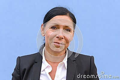 Woman with black hair wearing dark suit jacket Stock Photo