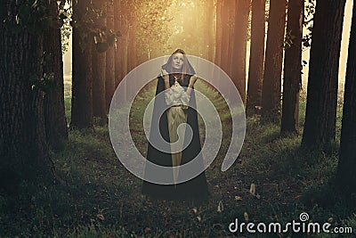 Woman with black robe in a surreal forest Stock Photo