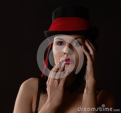 Woman in black tophat with red shawl Stock Photo