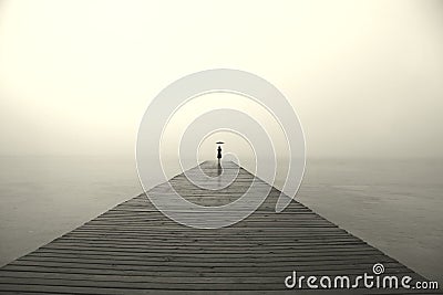 Woman with black umbrella looking infinity in a surreal place Stock Photo