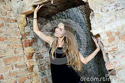 Woman in blak dress inside ruins Stock Photo