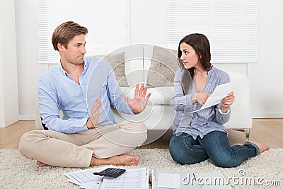 Woman Blaming Man For Excessive Expenses At Home Stock Photo