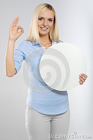 Woman with blank board and showing okay gesture Stock Photo