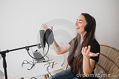Woman blogger recording radio podcast in studio. Stock Photo