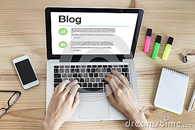 Woman blogging with laptop writing post entries Stock Photo
