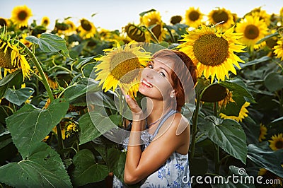 Woman on blooming sunflower field Stock Photo