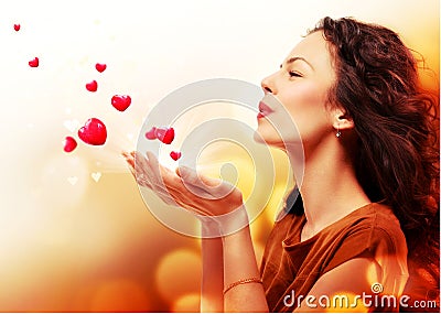 Woman Blowing Hearts from Hands Stock Photo