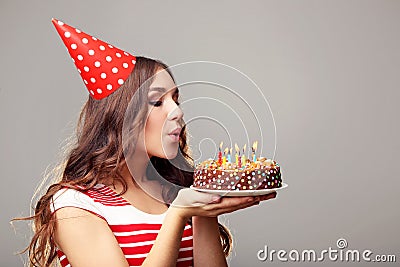 Woman blowing out candles Stock Photo