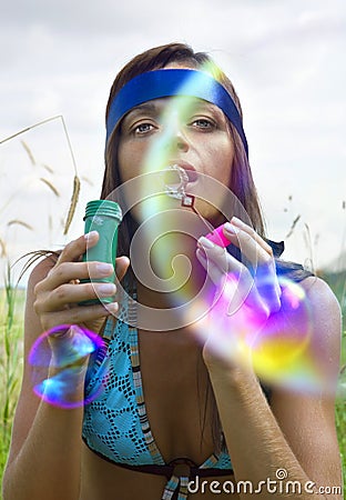 Woman blowing soap bubble Stock Photo