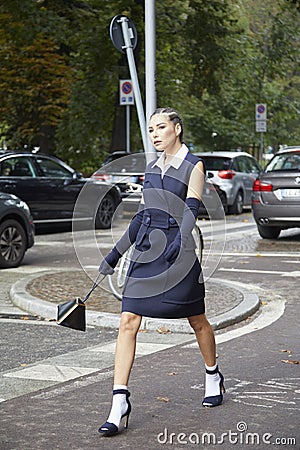 Woman with blue dress and white shirt walking before Sportmax fashion show, Milan Fashion Week Editorial Stock Photo