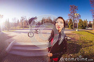 Woman and BMX cyclist doing a stunt jump Stock Photo