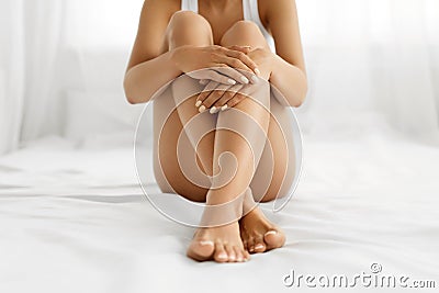 Woman Body Care. Close Up Of Long Legs With Soft Skin And Hands Stock Photo